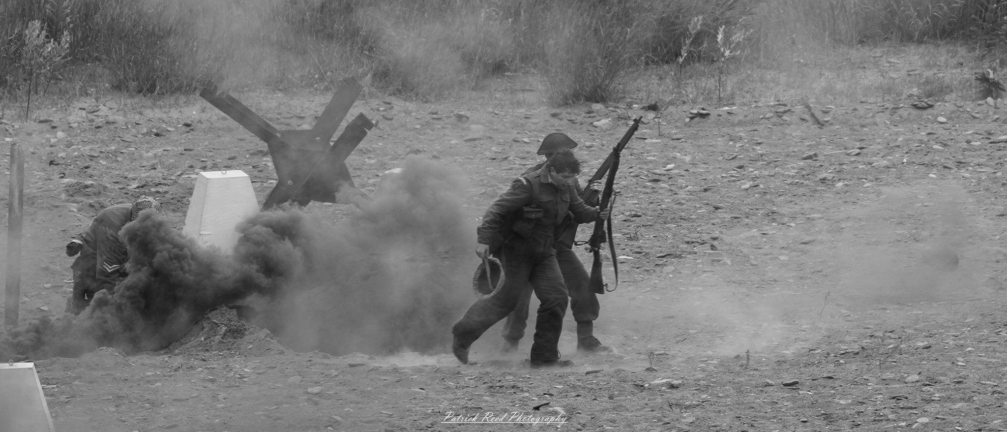 A powerful depiction of two soldiers walking across a battlefield, navigating through smoke and debris. The image captures their determination and camaraderie as they move forward amidst the chaos of war.